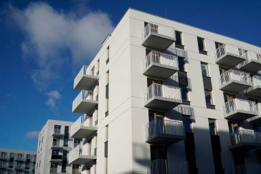 Warsaw, Poland, January 4th 2025 - Modern residential building with balconies. Real estate and housing issues concept. clipart