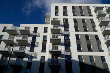 Warsaw, Poland, January 4th 2025 - Modern residential building with balconies. Real estate and housing issues concept. clipart