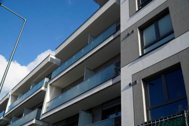 Warsaw, Poland, January 4th 2025 - Modern residential building with balconies. Real estate and housing issues concept. clipart