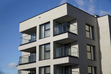 Warsaw, Poland, January 4th 2025 - Modern residential building with balconies. Real estate and housing issues concept. clipart