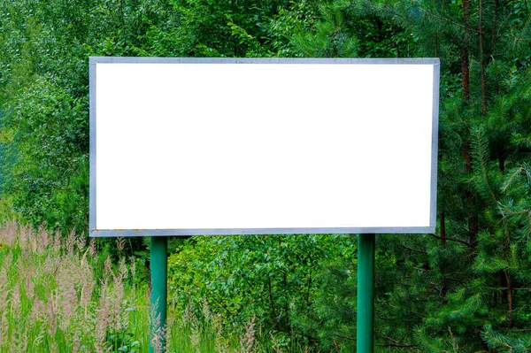 Roadside billboard outdoor advertising on the background of the forest. Roadside advertising billboard. Template for text. background image. Free space for text.