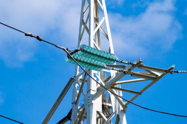 Line insulator on the electrical wires of a high-voltage tower. Electric wires. High-voltage power transmission tower. Electrical line insulators. Energy business. The beauty. clipart