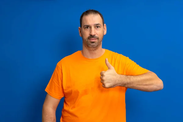 Bearded Handsome Hispanic Man Wearing Orange Casual Shirt Standing Isolated — Stock Photo, Image