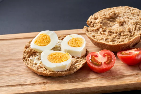 stock image                                Sandwiches with tomatoes, eggs and mayonnaise on a wooden plate.