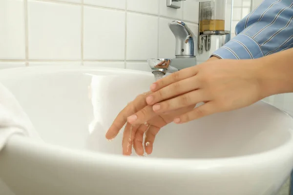 Woman clean hands in wash basin, close up