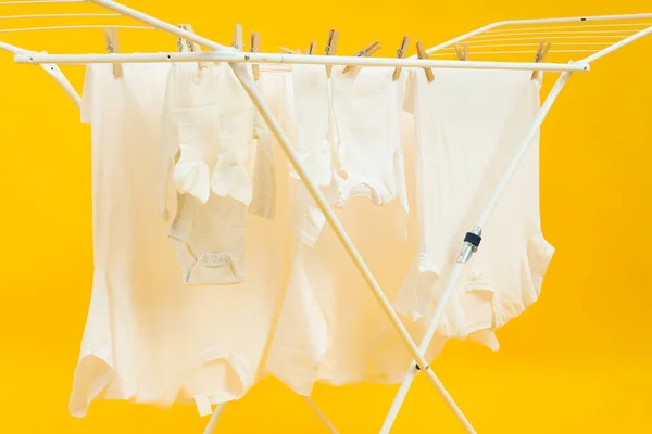 Drying Rack Different Clothes Yellow Background — Stock Photo, Image