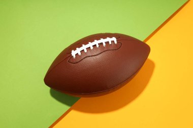 American football ball on two tone background