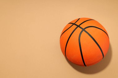 Basketball ball on beige background, concept of balls