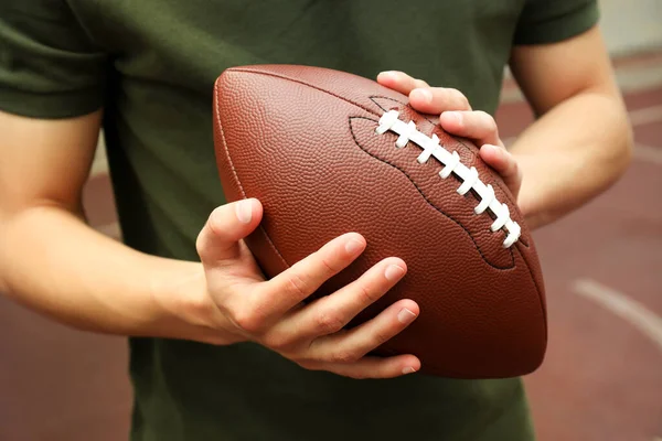 Man Holds American Football Ball Close Royalty Free Stock Images