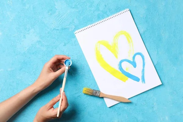 Concept of Help Ukraine, drawing of two yellow and blue hearts