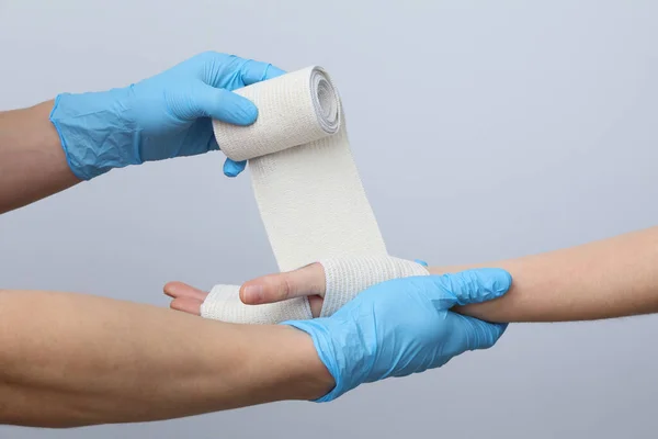 Concept of hand injury help with elastic bandage