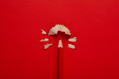 Red pencil on red background, close up
