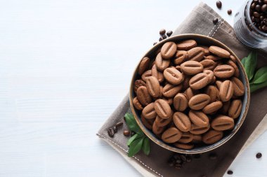 Concept of tasty snack for hot drink - cookies in the shape of coffee seeds