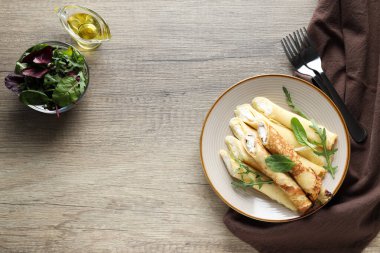 Concept of tasty food, thin pancakes with filling, space for text