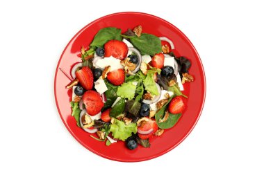 Plate of salad with strawberry isolated on white background