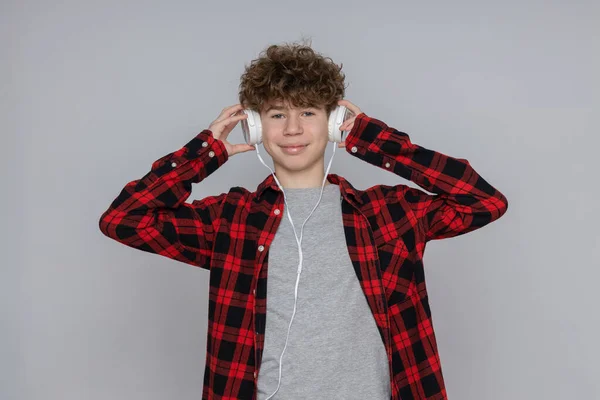 stock image Attractive boy, teenager in headphones on gray background