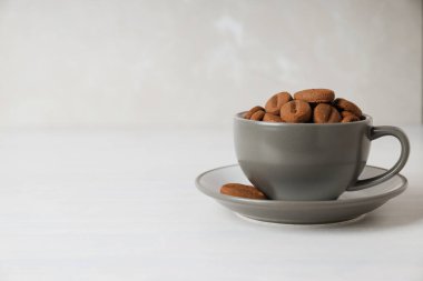 Concept of tasty snack for hot drink - cookies in the shape of coffee seeds