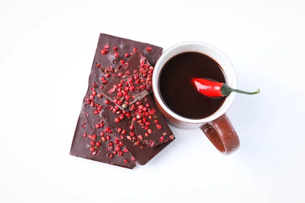 Chocolate with pepper and hot chocolate drink with pepper, isolated on white background