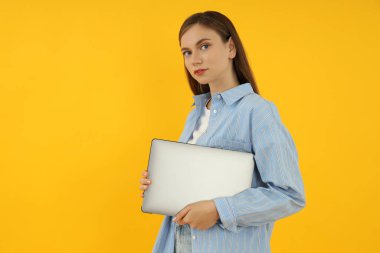 Concept of people, young woman on yellow background