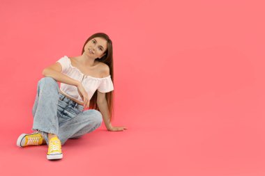 Concept of people, young woman on pink background