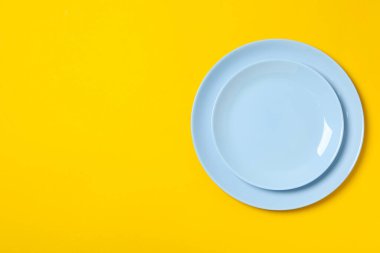 Sarı arkaplanda boş tabaklar, metin için boşluk