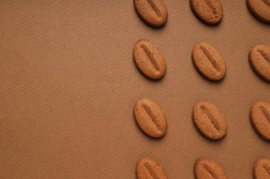 Concept of tasty snack for hot drink - cookies in the shape of coffee seeds