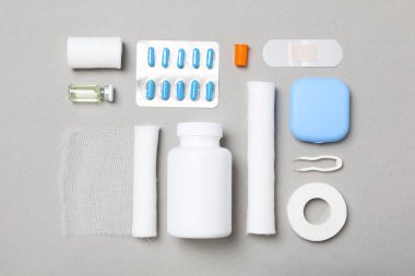 First aid kit supplies on gray background