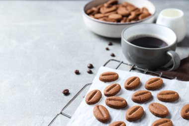 Concept of tasty snack for hot drink - cookies in the shape of coffee seeds