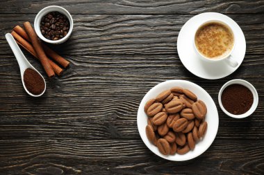Concept of tasty snack for hot drink - cookies in the shape of coffee seeds
