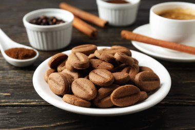 Concept of tasty snack for hot drink - cookies in the shape of coffee seeds