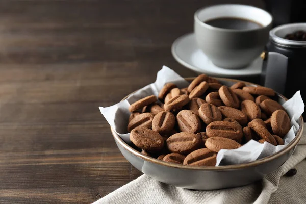 Concept of tasty snack for hot drink - cookies in the shape of coffee seeds