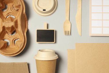 Açık gri arkaplanda el işi aksesuarları olan düz maket.