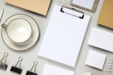 Mockup dairesi açık gri arka planda farklı ofis aksesuarları ile yatıyordu