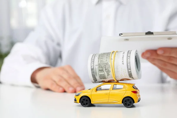 Concept of car purchase and insurance with toy car