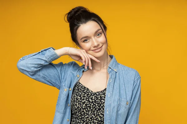 stock image Young woman in a denim shirt, hair tied up