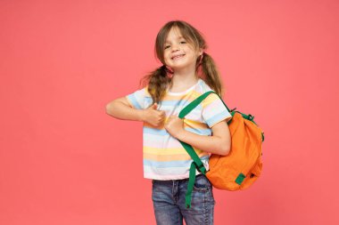 Omzunda sırt çantası olan küçük bir kız