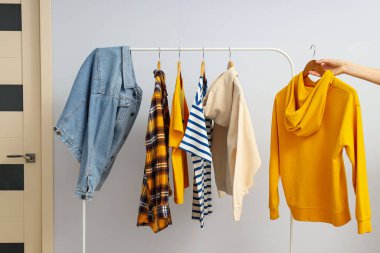 Farklı kıyafetlerle gardırop rafı, farklı kıyafet konsepti.