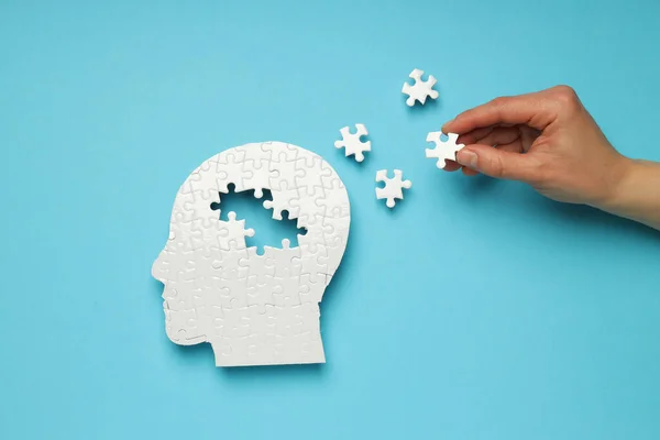 stock image Puzzle head with missing elements on a blue background