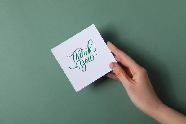 Надпись Спасибо Бумаге Руках Зеленом Фоне — стоковое фото