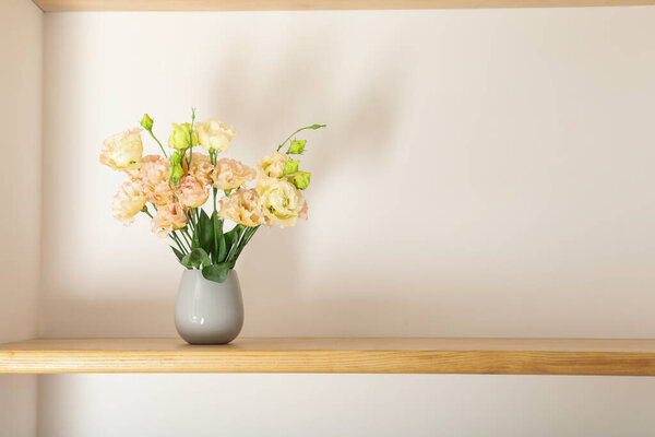 A beautiful vase with flowers on a shelf