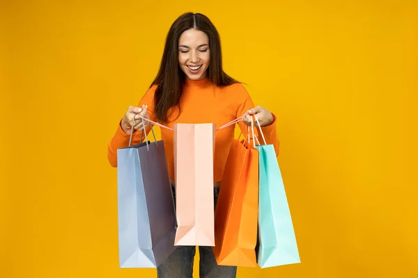 Cheerful Young Woman Shopping Bags Her Hands Yellow Background — Stock Photo, Image