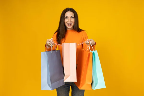 Cheerful Young Woman Shopping Bags Her Hands Yellow Background — Stock Photo, Image