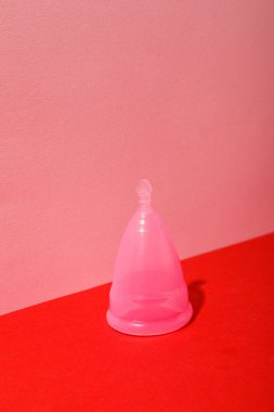 Pembe üzerine kırmızı arka planlı adet bardağı.