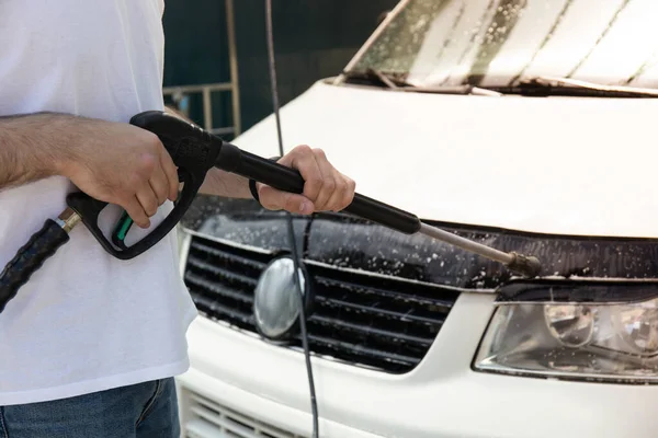 stock image A man washes a car at a self-service car wash