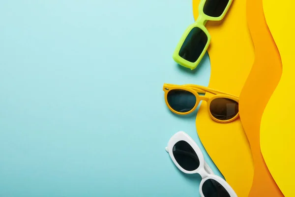 stock image The concept of glasses on the beach, on a colored paper background