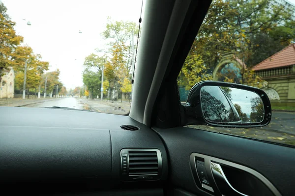 Rearview mirror of a car in rainy weather