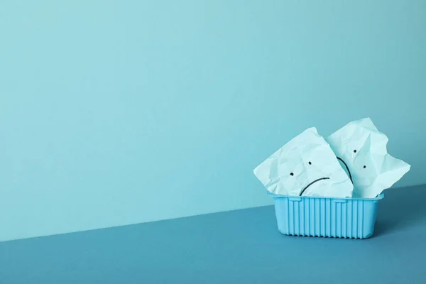 stock image Blue box with papers with sad emoji on blue background, space for text