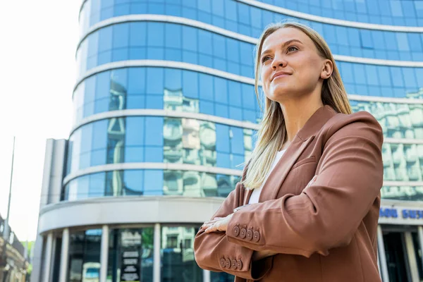 Confident woman in suit against the backdrop of business center