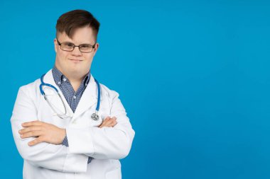 Serebral felçli gülümseyen genç adam steteskoplu gözlük takıyor. Dünya Genetik Hastalıklar Günü konsepti, metin için yer