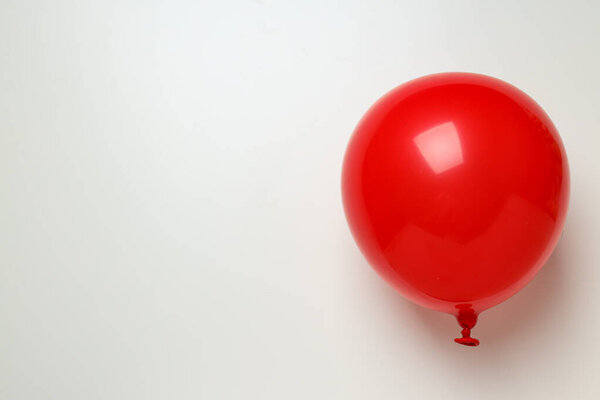 Red balloon on white background, space for text
